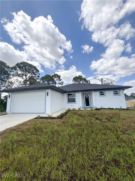 View of front facade with concrete driveway, an at