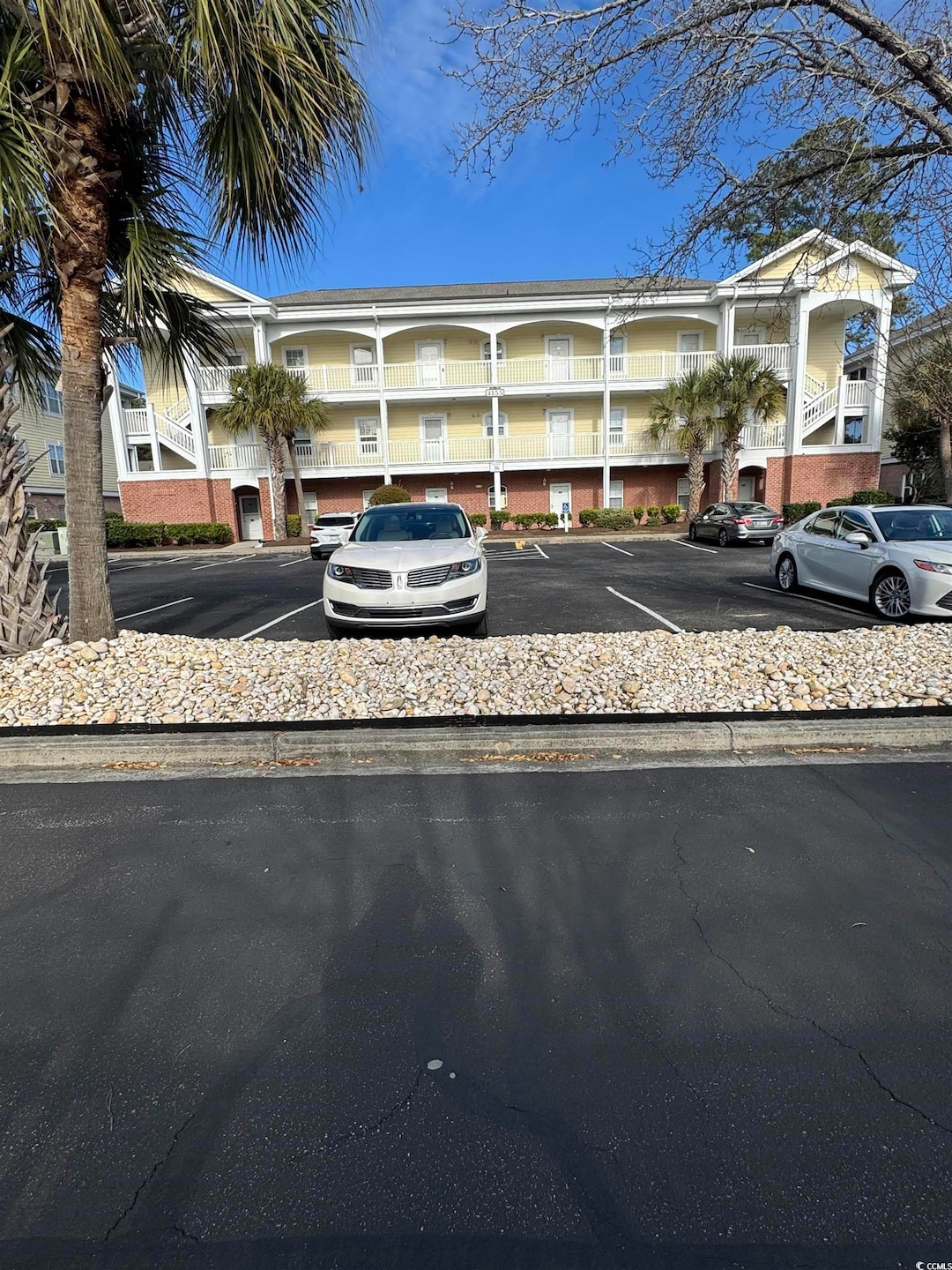 View of property featuring uncovered parking