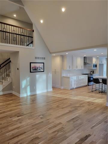 2nd floor overlooks dramatic vaulted ceiling
