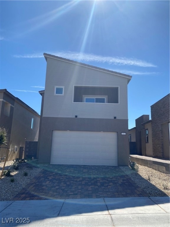 Modern home featuring stucco siding, decorative dr