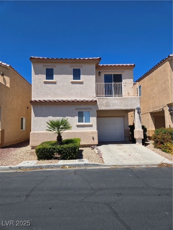 View of front of home with a balcony, stucco sidin