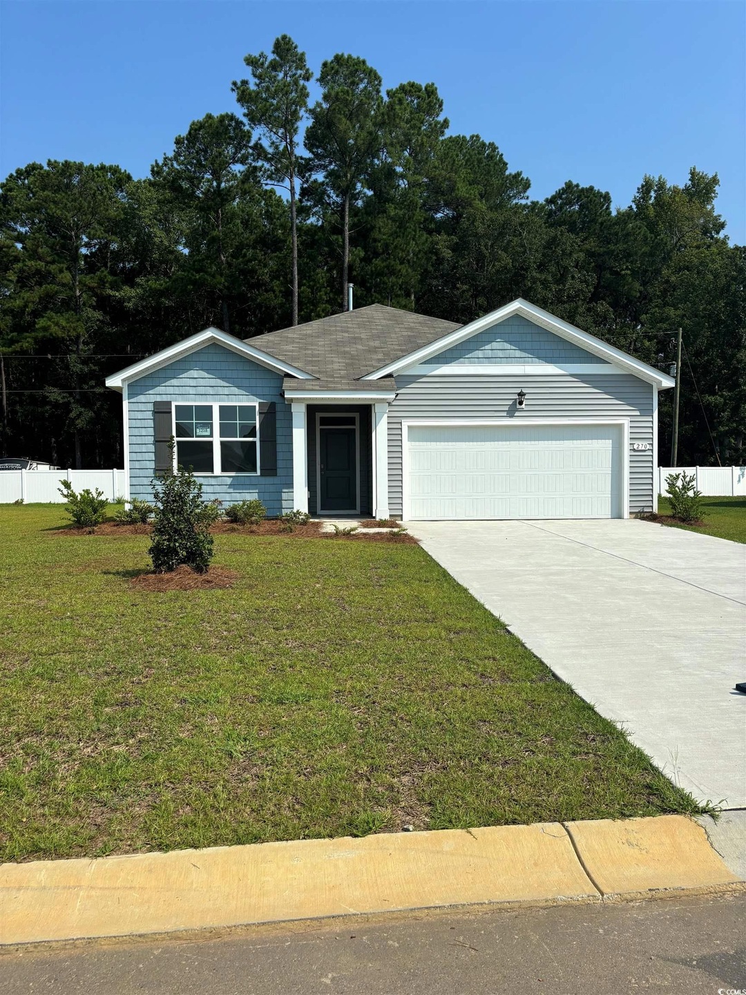 Single story home with a front yard and a garage