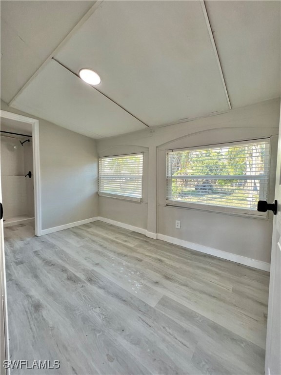 Empty room featuring baseboards and wood finished floors