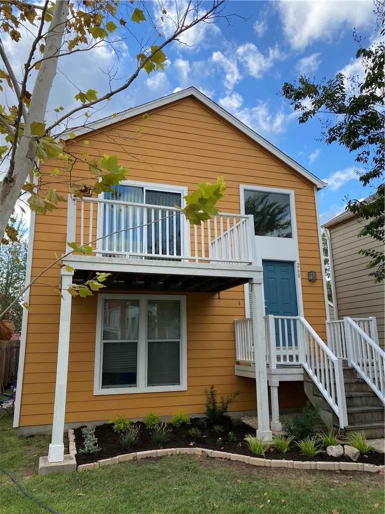 View of front of property with a balcony