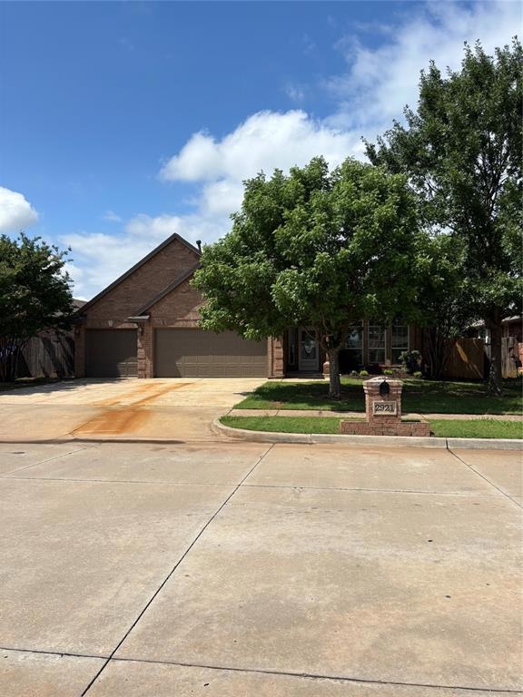 View of front of home with concrete driveway and a garage