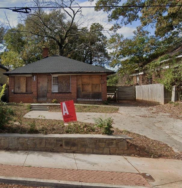 View of front of home featuring a shingled roof, a