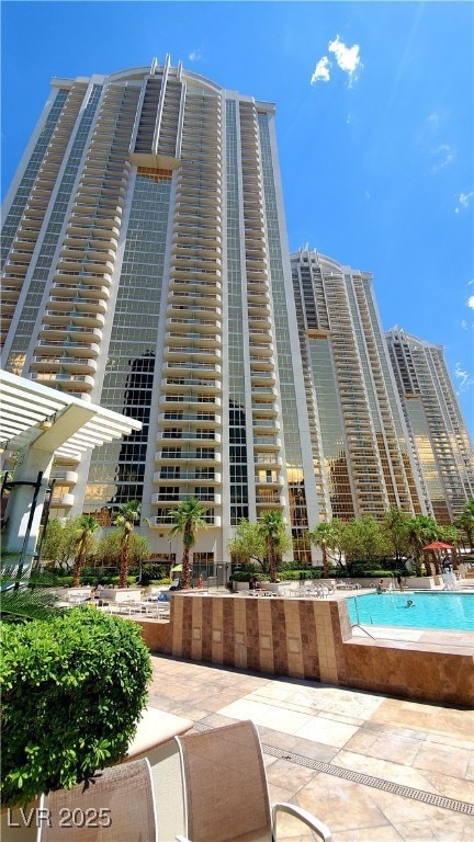 View of building exterior with a community pool