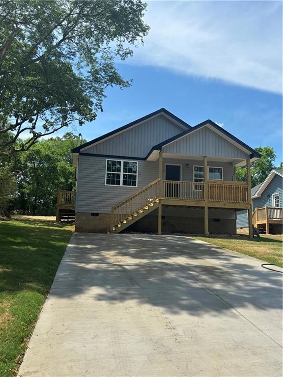View of front of home with a porch and a front law