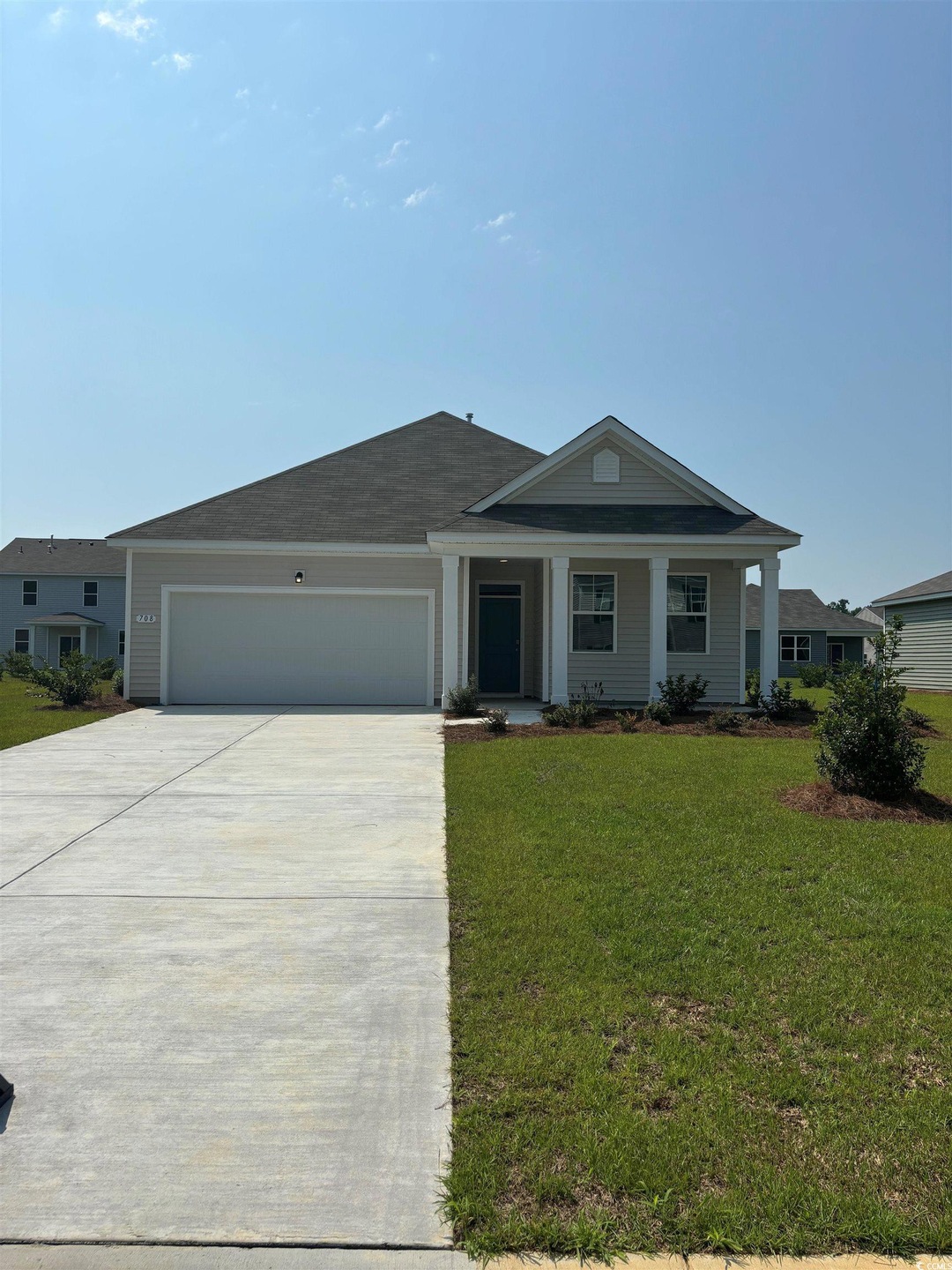 Single story home with a garage and a front yard