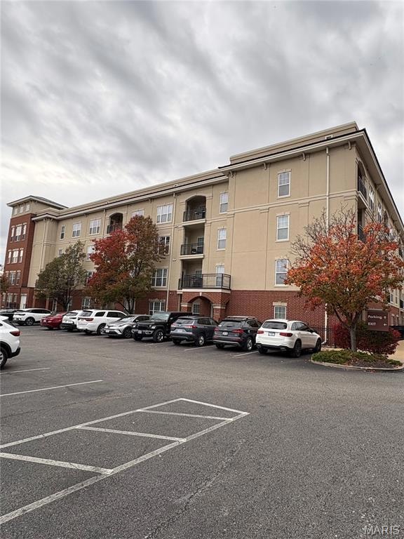 View of property with uncovered parking