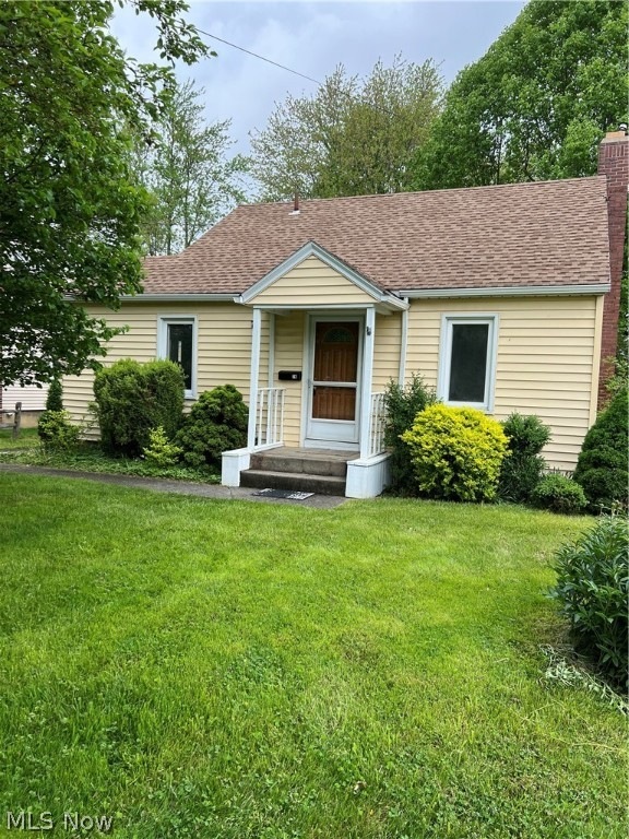 View of front of house featuring a porch and a front lawn