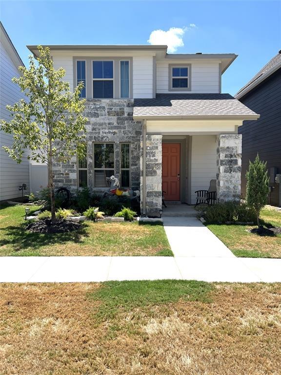 FRONT OF THE HOME WITH SIDEWALKS