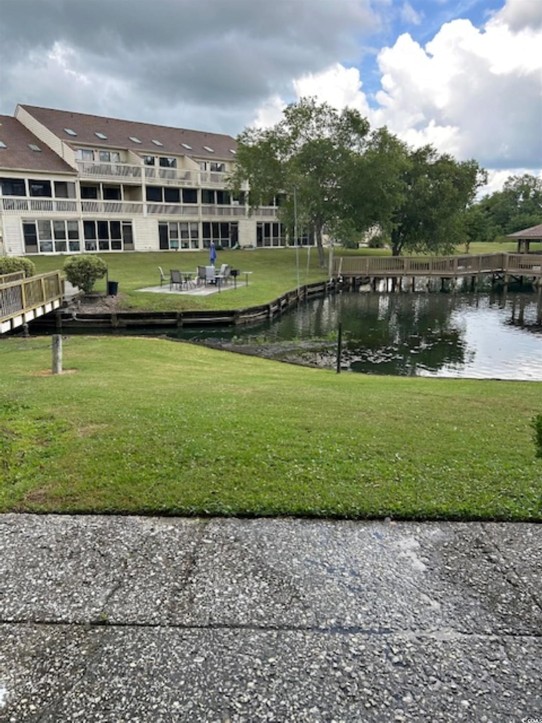 View of property's community featuring a water view and a yard