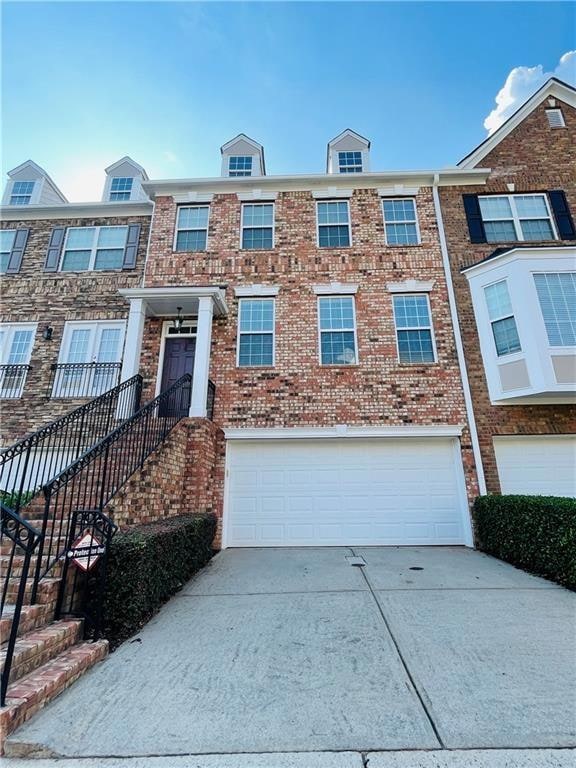 Townhome / multi-family property with a garage