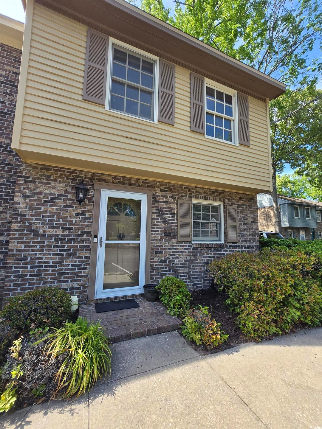View of front of home featuring brick siding