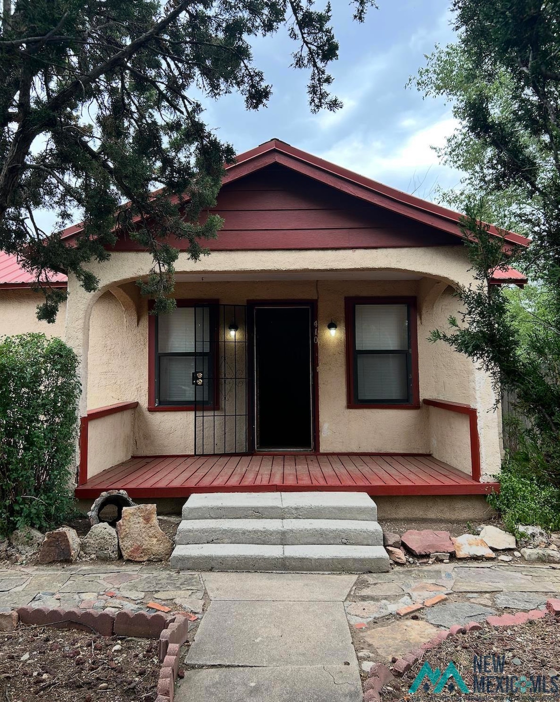 Property entrance with stucco siding and a porch