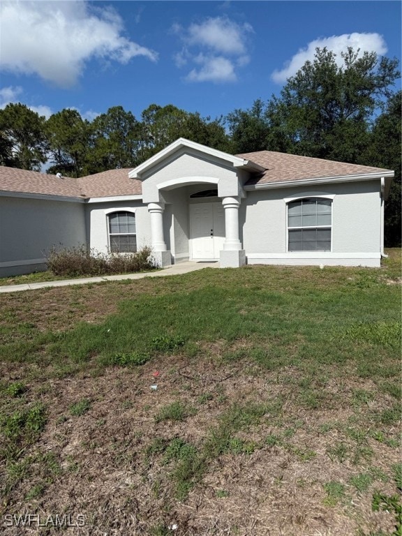 Single story home with stucco siding, a front yard