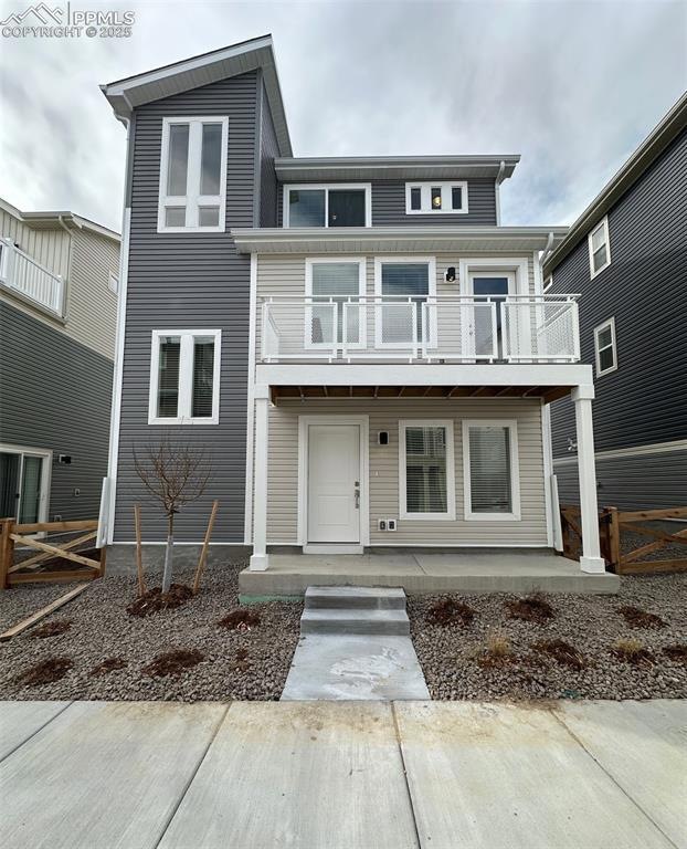 View of front facade with a balcony and fence
