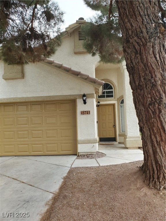 View of front of home featuring stucco siding, con