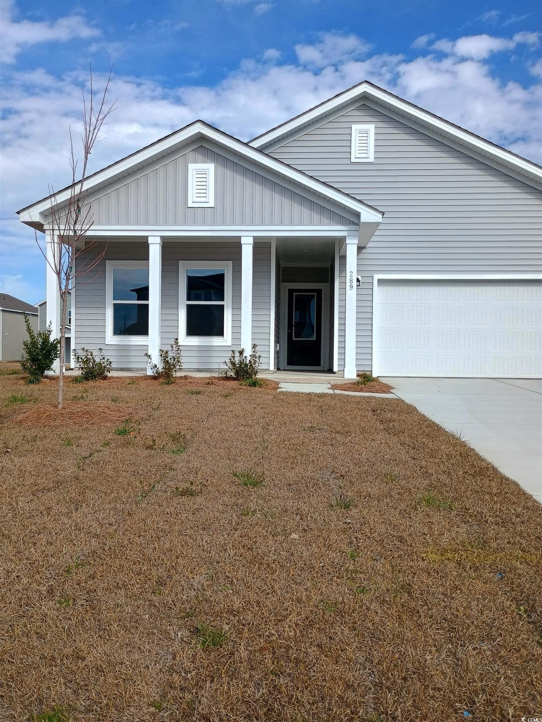 View of front of home with driveway, a garage, a f