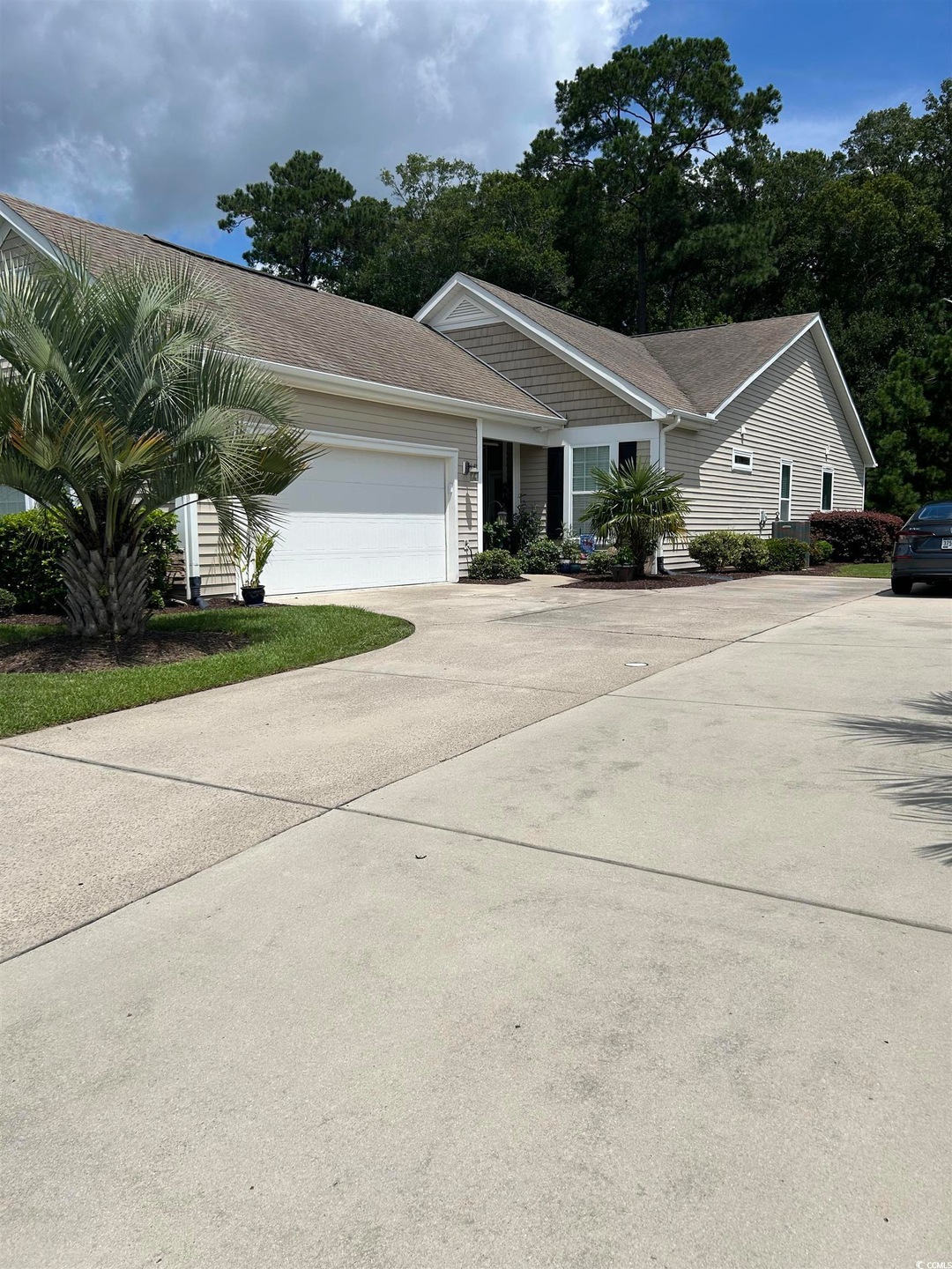 View of front of home featuring an attached garage and driveway