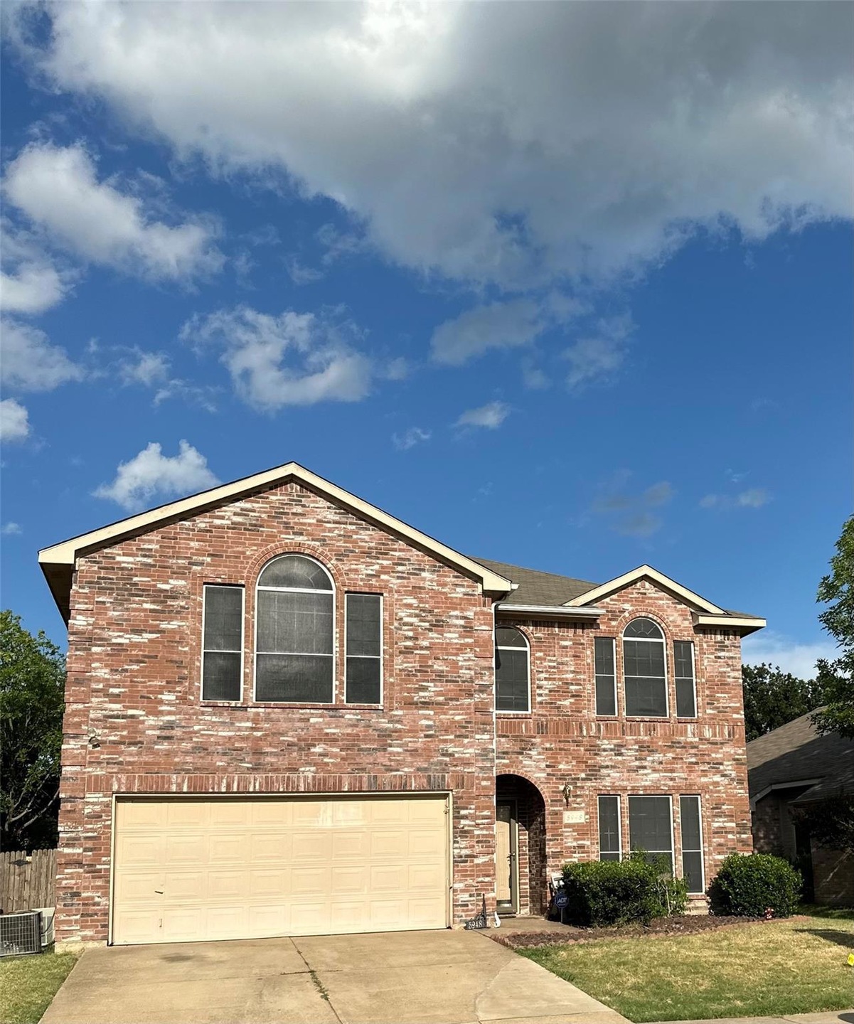 View of front of house with a garage, central air 