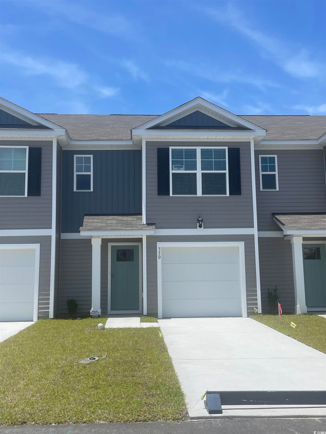 View of front of home featuring driveway, a garage, and a front yard