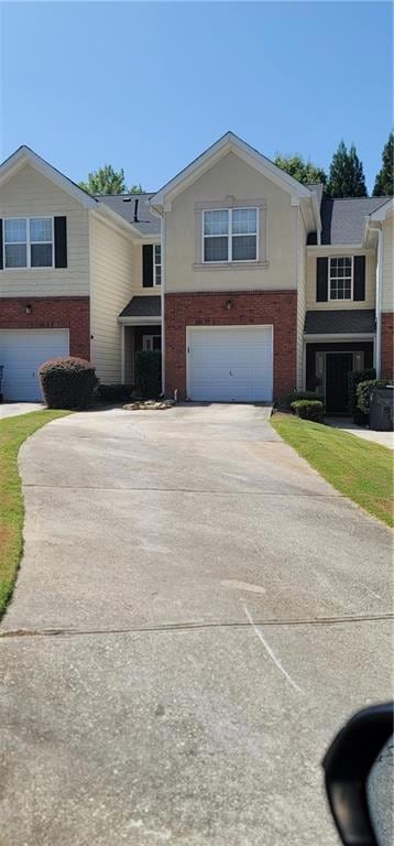 View of front of property with a garage and long d