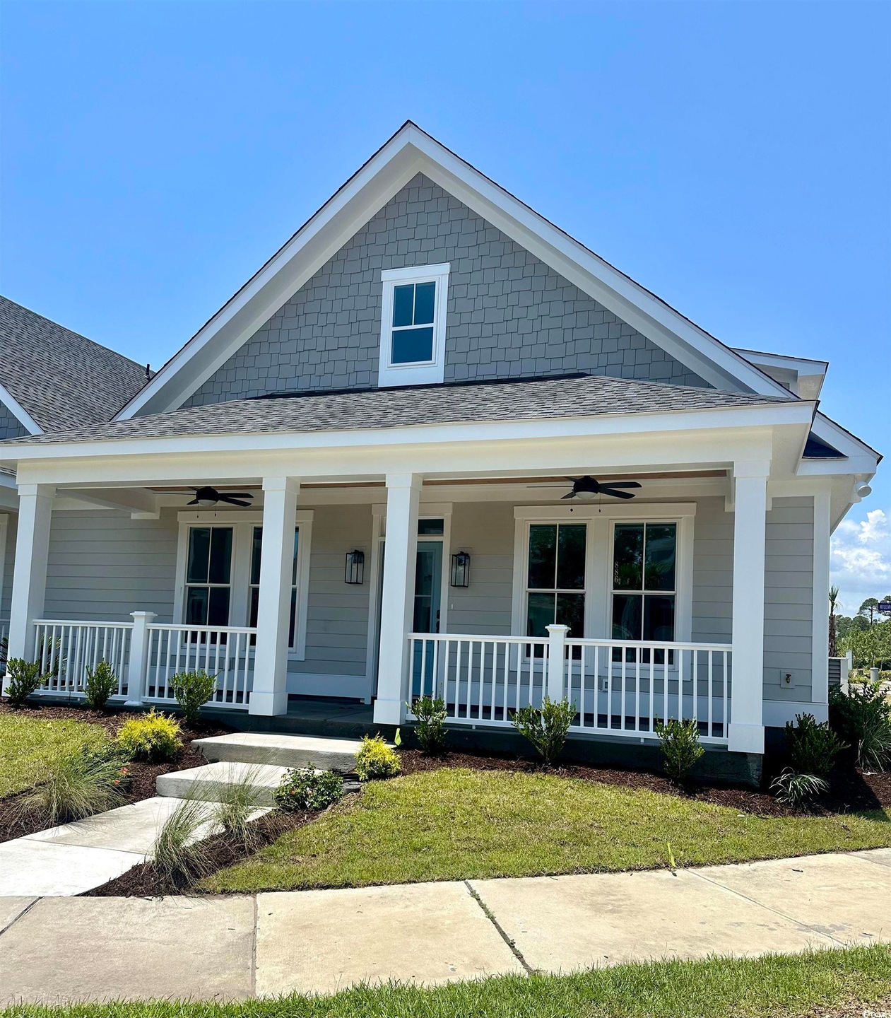 View of front of house featuring ceiling fan and a