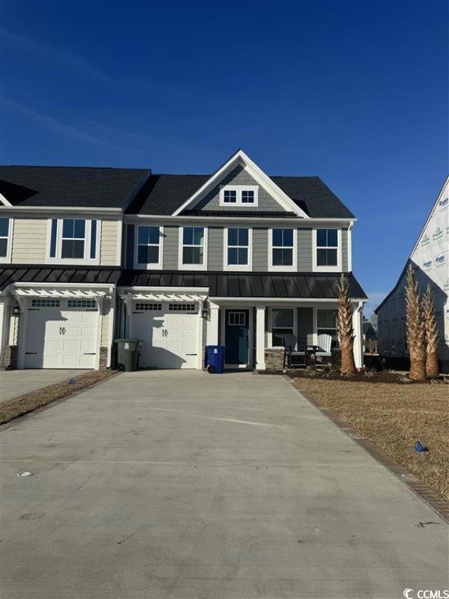 View of front facade featuring a garage