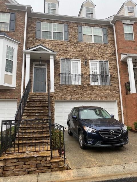 Townhome / multi-family property featuring an atta