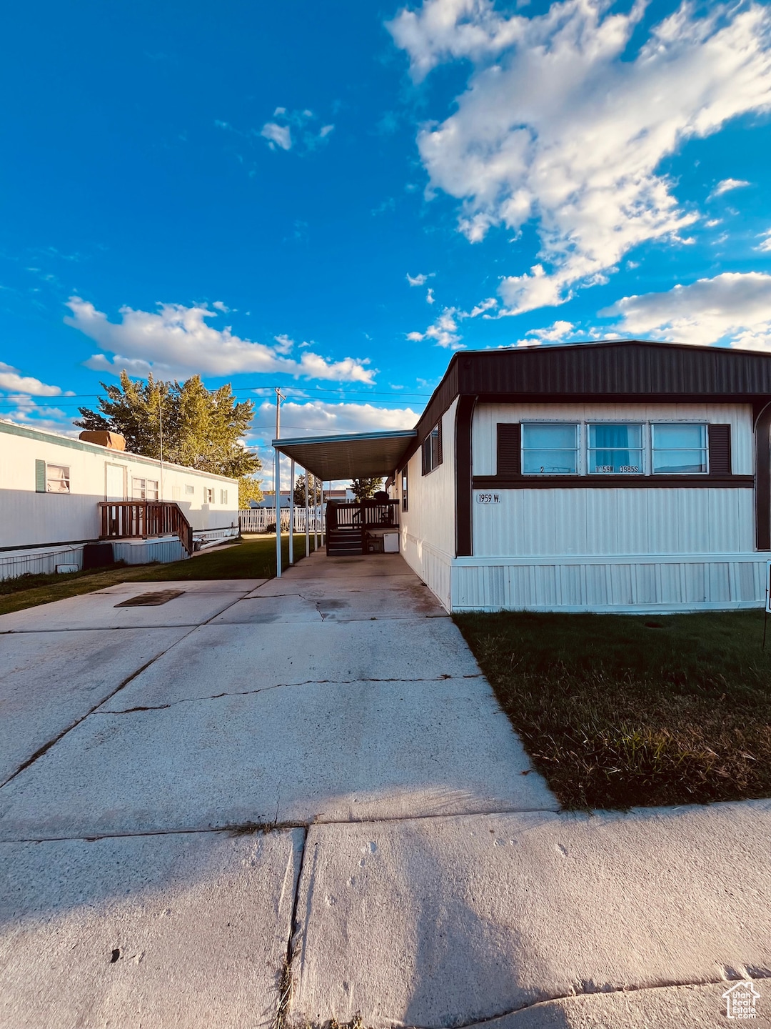 View of home's exterior with driveway and an attached carport