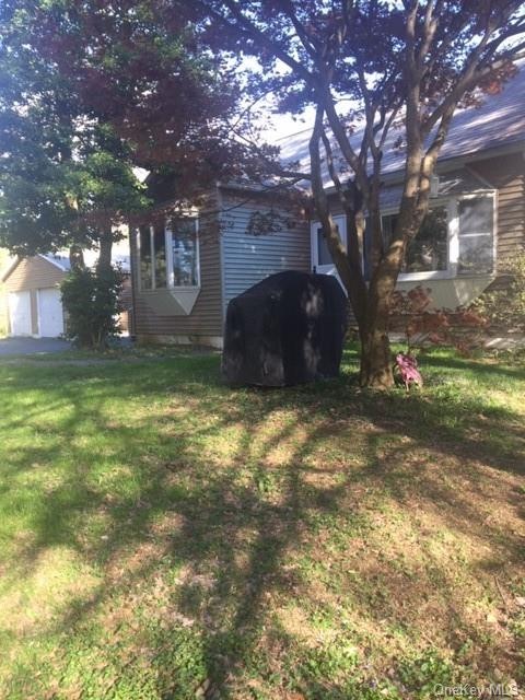 FRONT OF HOUSE w/ATTACHED 1-CAR AND DETACHED 2-CAR GARAGES.