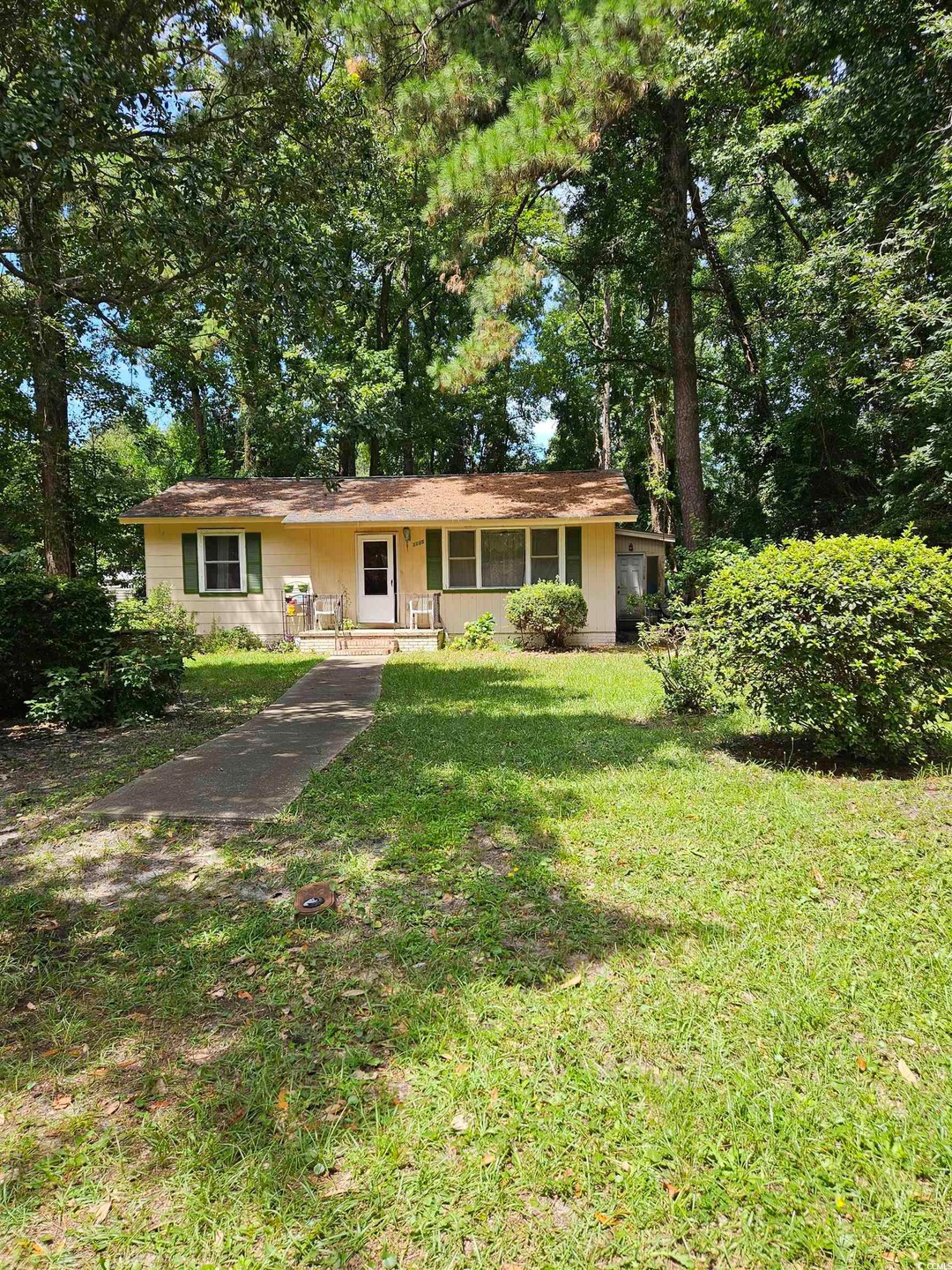 Single story home featuring a front lawn