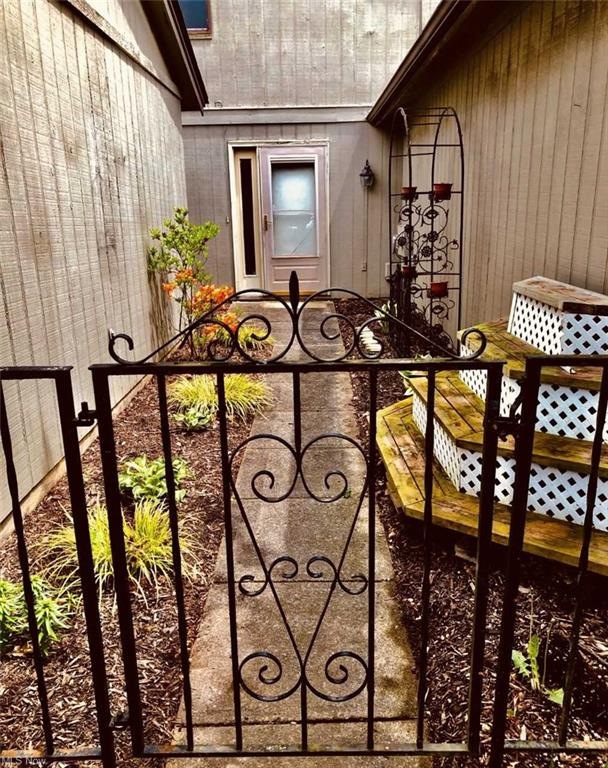 Private front door entrance to the home.  Owners have enjoyed planting and displaying summer annuals here.