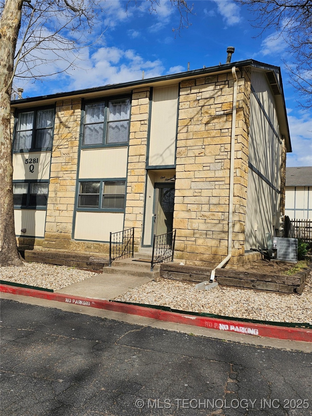 View of property with central AC unit