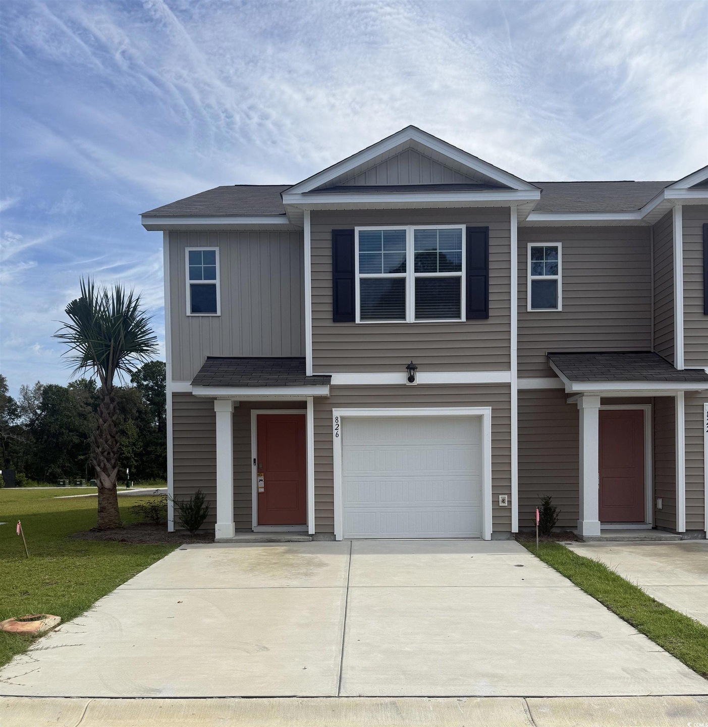View of front of property with roof with shingles, an attached garage, and concrete driveway