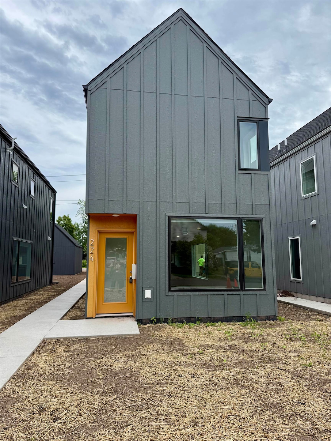 Rear view of property with board and batten siding