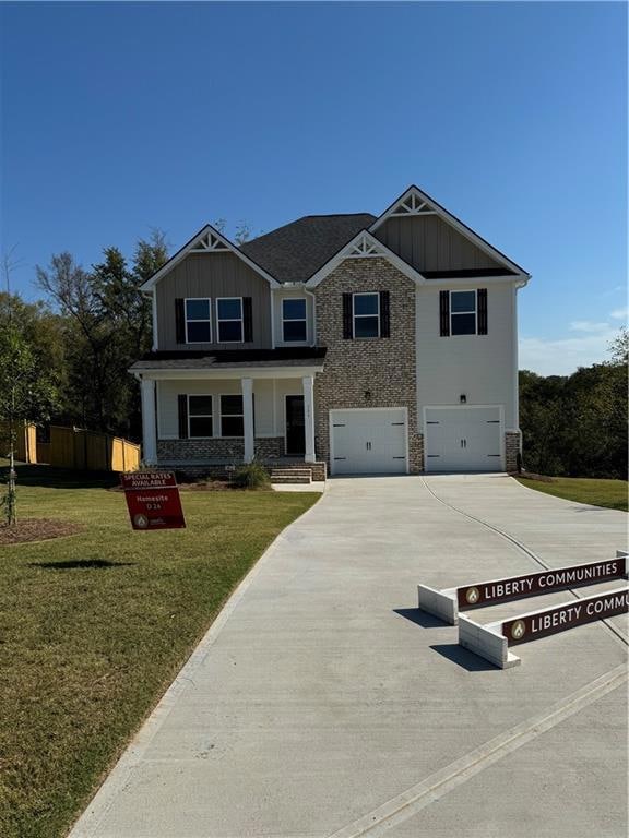 Craftsman-style house with a front yard and a gara