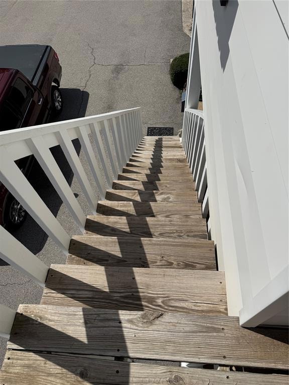 Stairs featuring wood finished floors
