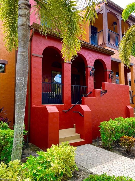 View of exterior entry featuring stucco siding