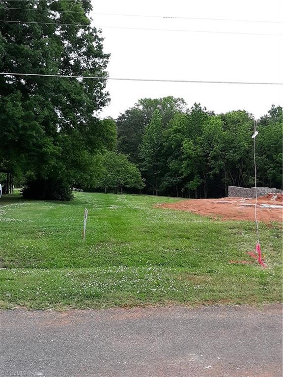 Facing the front entrance of the land. Pink ribbon on right  over to pink paint in driveway to the left.
