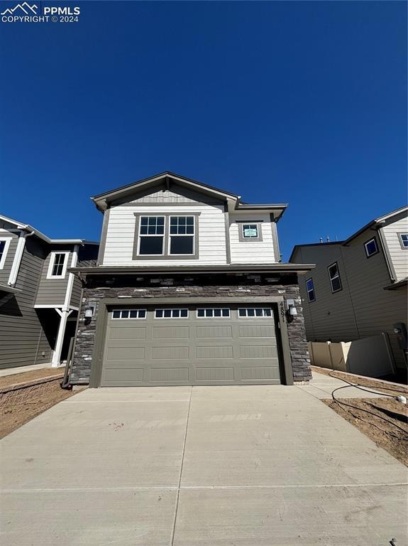 View of front facade featuring a garage