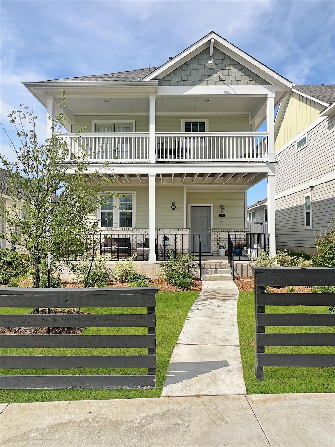 View of front of property with a balcony and cove