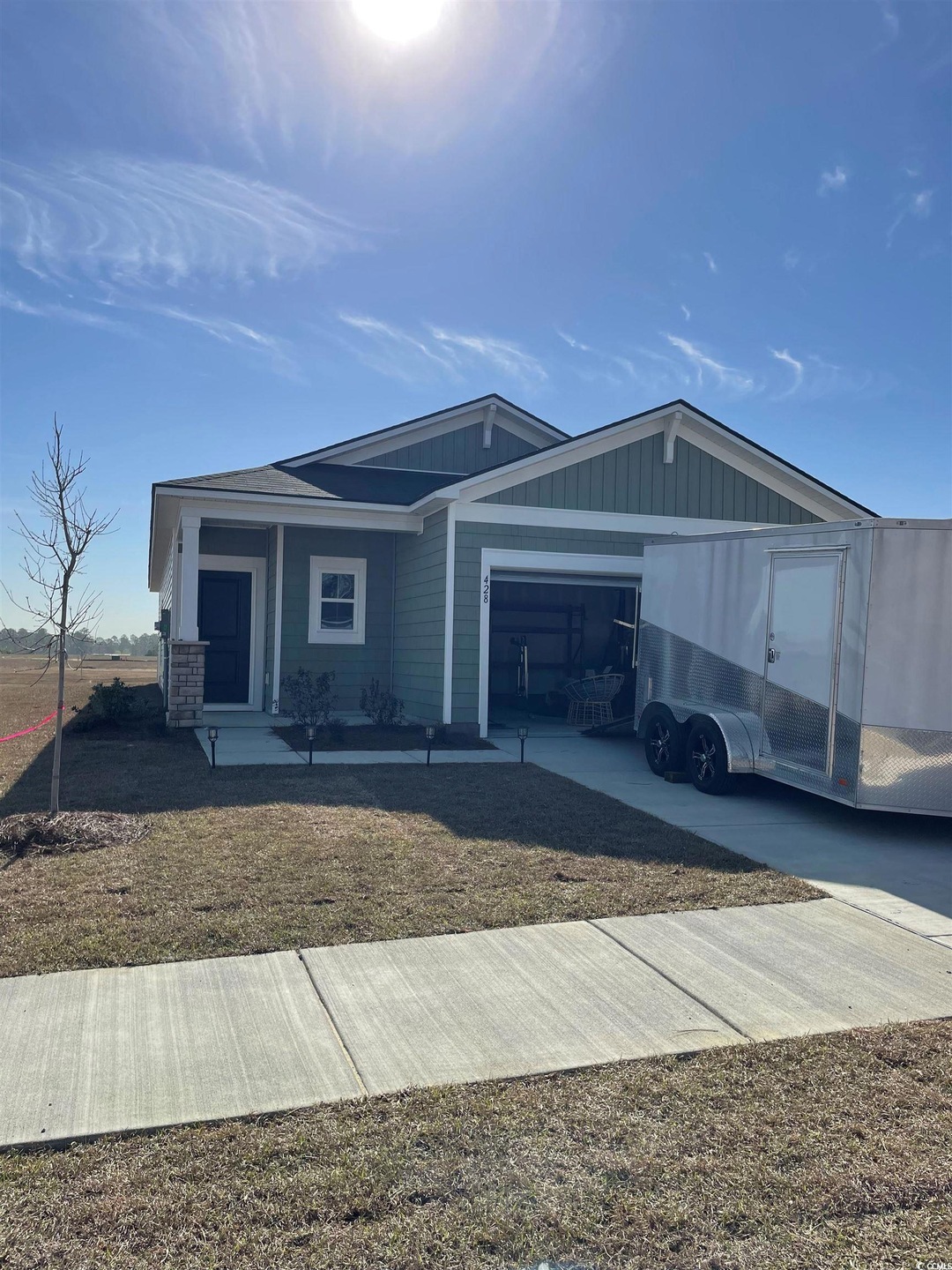 View of front of house featuring a garage and boar