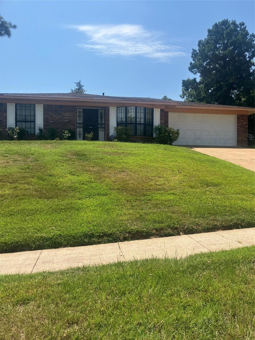 Ranch-style house with a front lawn and a garage