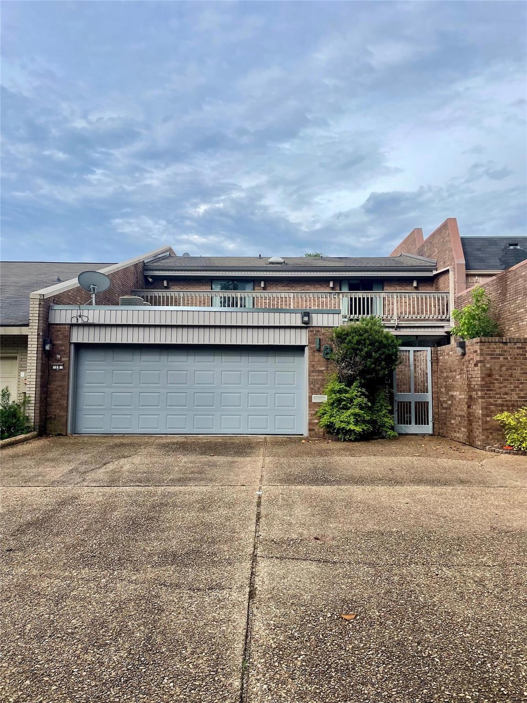 View of back of home featuring a garage