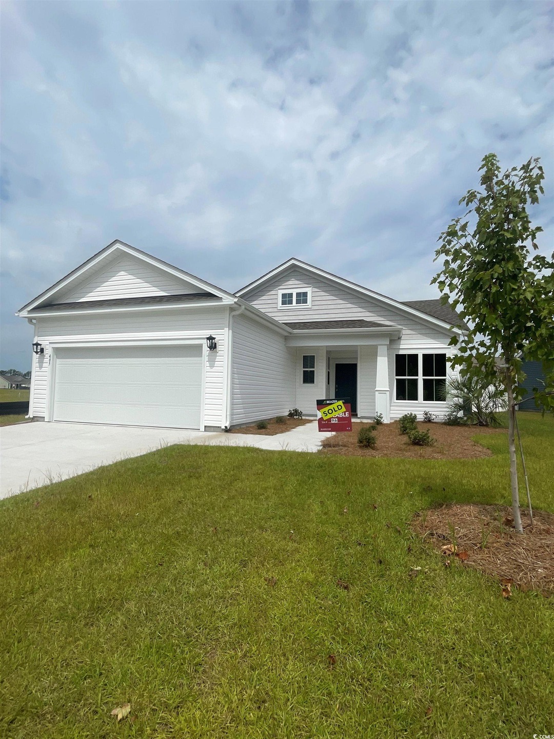 Single story home featuring a front lawn and a gar