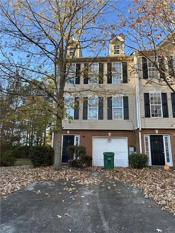 View of front of house with brick siding, a garage