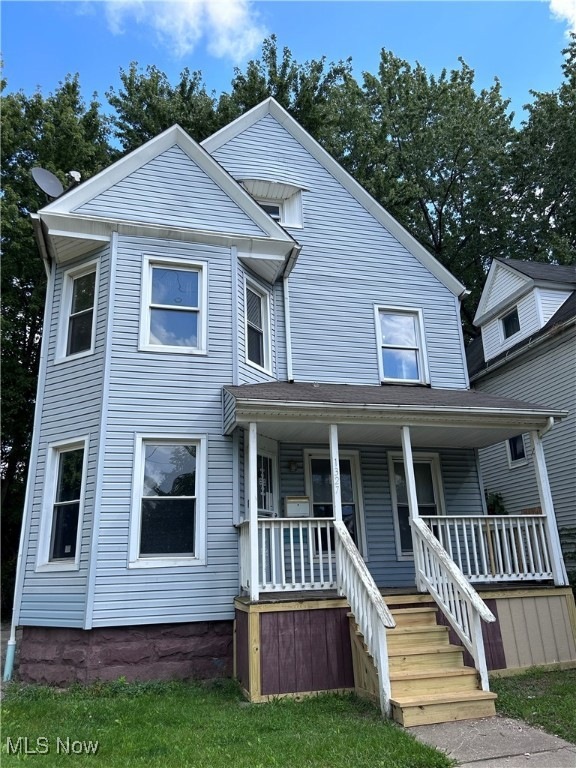 View of front facade with a porch and a front yard